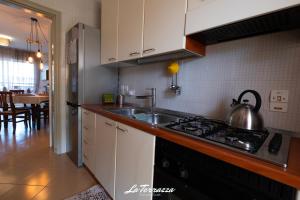 a kitchen with a sink and a stove top oven at La Terrazza in Noicattaro
