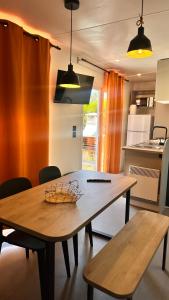a kitchen with a wooden table and two benches at Camping Villa Park Zambujeira do Mar in Zambujeira do Mar