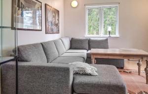 a living room with a couch and a table at Lovely Home In Rimforsa With Lake View in Rimforsa