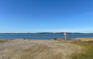 a no swimming sign next to a large body of water at Nice Home In Roslev With Wifi in Roslev +15 photos