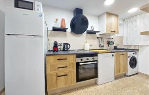 a kitchen with white appliances and a white refrigerator at 2 Bedroom Amazing Apartment In Cullera in Cullera