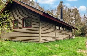 a log cabin with windows on the side of it at 2 Bedroom Gorgeous Home In Ebeltoft in Ebeltoft +7 photos