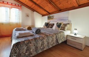 a bedroom with a large bed and a window at 2 Bedroom Lovely Apartment In Lovran in Lovran