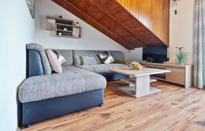 a living room with a couch and a table at 2 Bedroom Lovely Apartment In Lovran in Lovran +13 photos