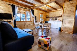 a living room with a blue couch and a table at Brvnare Bor i Jela in Vrdnik