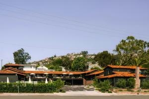 a group of houses with a hill in the background at Woods Cove Inn in Laguna Beach