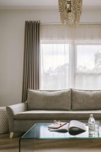 a living room with a couch and a glass table at Hotel Beverly Terrace - Beverly Hills West Hollywood in Los Angeles +43 photos