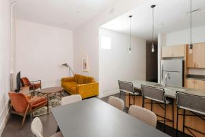 a kitchen and living room with tables and chairs at Sonder by Marriott Bonvoy The Gallier Apartments CBD in New Orleans