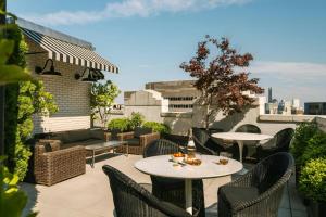 a patio with tables and chairs on a roof at Nester Finn Financial District in New York