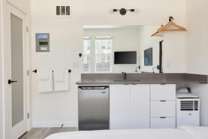 a kitchen with a sink and a counter top at The Boylston Hotel Capitol Hill in Seattle