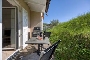 a table and chairs on the porch of a house at Neda Apartment In Krasno Among Vineyard - Happy Rentals in Šmartno