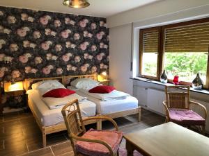 En eller flere senge i et værelse på Gruppenhaus das Waldcafe