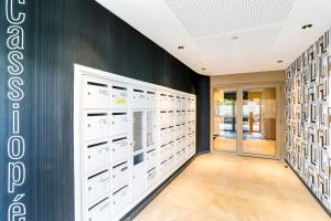 a dressing room with white cabinets and a black wall at Home Sweet Home in Bezons