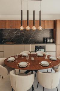 Un comedor con mesa y sillas de madera. en Casa Nolimi, en Fažana