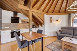 a kitchen and living room with a wooden ceiling at Haus Ella in Königsfeld im Schwarzwald