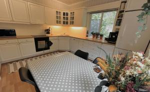 a kitchen with a table in the middle of it at Anchor Point Farsund in Farsund