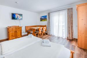 Postel nebo postele na pokoji v ubytování Hotel Garni Nuss