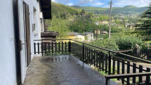 a balcony with a view of a city at Sweety Home in Pievepelago