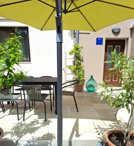 a patio with a table and chairs and an umbrella at Apartment Relax & Wine in Novigrad Istria