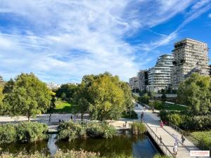 a river in a city with tall buildings at Best Western Plus Opéra Batignolles in Paris