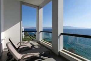 a room with two chairs and a view of the ocean at Xanadu Island in Akyarlar