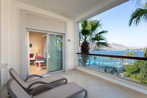 a room with a balcony with a view of the ocean at Xanadu Island in Akyarlar