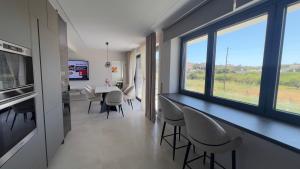 a kitchen and dining room with a table and chairs at CasaMare Lagonisi Athens Riviera Luxury modern villas apartment's in Lagonissi