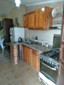 a kitchen with wooden cabinets and a stove top oven at Doctor's village in Alexandria