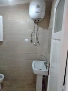 a small bathroom with a toilet and a sink at Doctor's village in Alexandria
