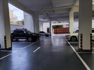 a parking garage with two cars parked in it at Purplehaze Place in Nairobi