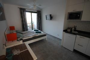 a kitchen with a bed in a room with a window at Casa Linda in Costa Teguise