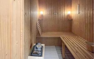 a sauna with wooden walls and stairs in it at Cozy Home In Fårevejle in Fårevejle +14 photos