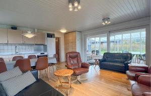 a kitchen and living room with a couch and a table at Cozy Home In Fårevejle in Fårevejle