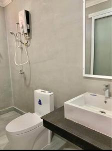a white bathroom with a toilet and a sink at UCS GUESt HOUSE in Siem Reap +12 photos