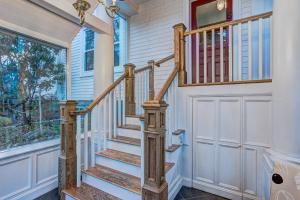 a wooden staircase in a home with a window at The Kinley House in Lunenburg