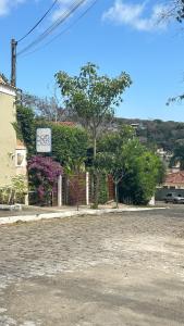 a building with a sign on the side of a street at Bossa Nova Búzios Pousada Home in Búzios