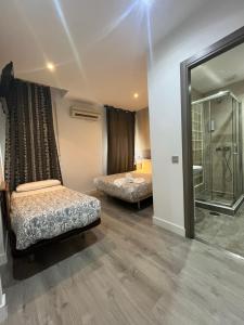 Łóżko lub łóżka w pokoju w obiekcie Hostal Abril Madrid