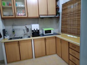 a kitchen with a sink and a microwave on the counter at Gurney PENstay in George Town