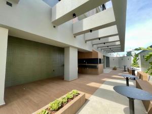 a building with a patio with tables and chairs at Santa Maria Aluguel Temporada in Chapecó