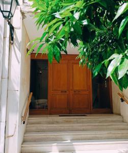a wooden door in a building with stairs at Rastoni Athens Suites near Acropolis in Athens