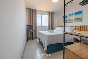 a bedroom with a bed and a desk in it at Apartamentos em Condomínio com Piscina e Academia - AGA in Camaçari +30 photos