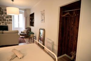 a living room with a bed and a mirror at La Brocante - Meilleurhote-Brioude in Brioude