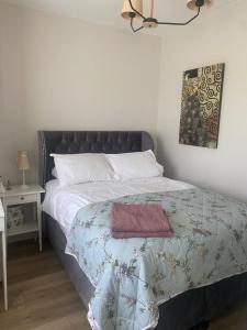 a bedroom with a bed with a red towel on it at Castletroy Retreat 1 bedroom apartment with addition of single bed to living room in Limerick +7 photos
