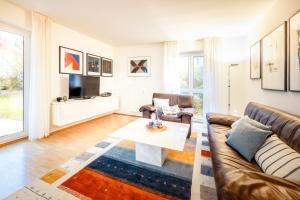 a living room with a couch and a table at Haubentaucher in Hemmenhofen