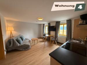 a living room with a couch and a table at Ferienwohnung Zum Böhmischen Bürgergarten in Radebeul