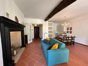 a living room with a blue couch and a fireplace at Palazzo Gamba Denti Apartment by Gottschalk in Bellano