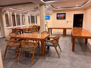 a dining room with wooden tables and chairs at Parikshit Inn in Ukhimath