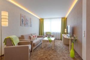 a living room with a couch and a table at Belvita Ferienwohnung 1 mit Hallenbad & Sauna in Willingen