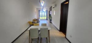a dining room with a white table and chairs at K avenue family room by TZ homestay in Donggongon