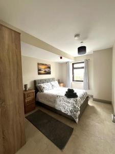 a bedroom with a bed and a window at Tigh Fitz Apartments - Inis Mór, Aran Island in Inis Mor